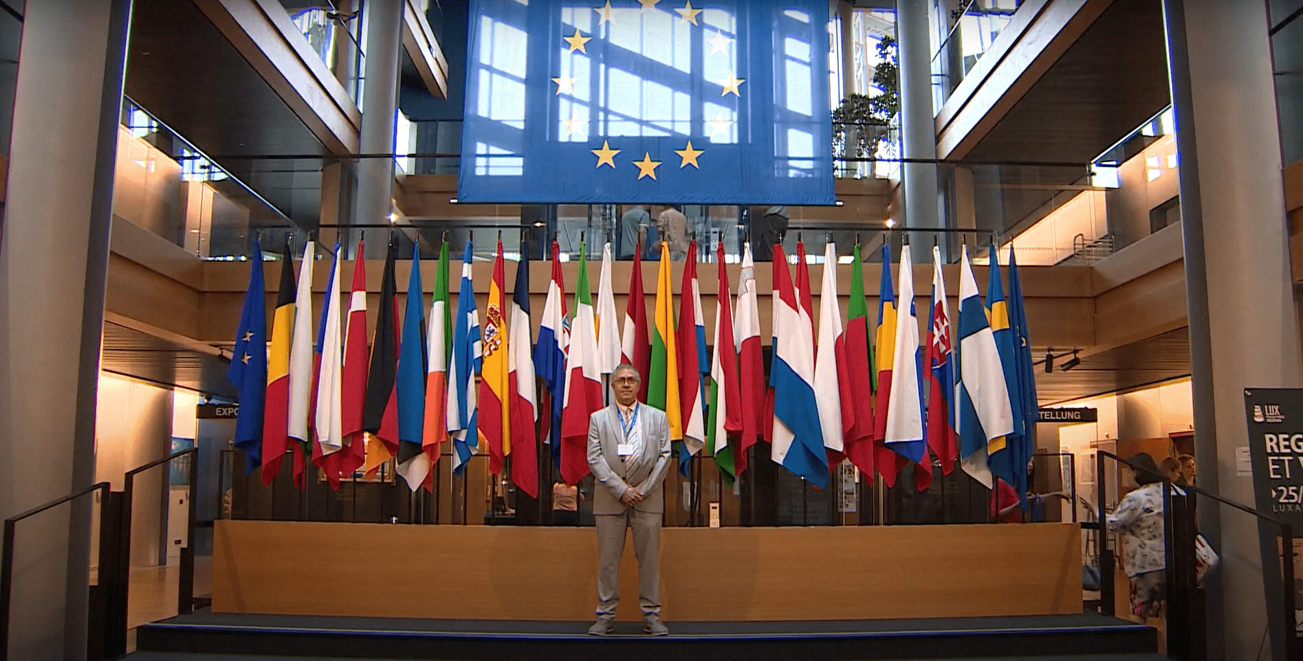 teacher standing in front of EU flags